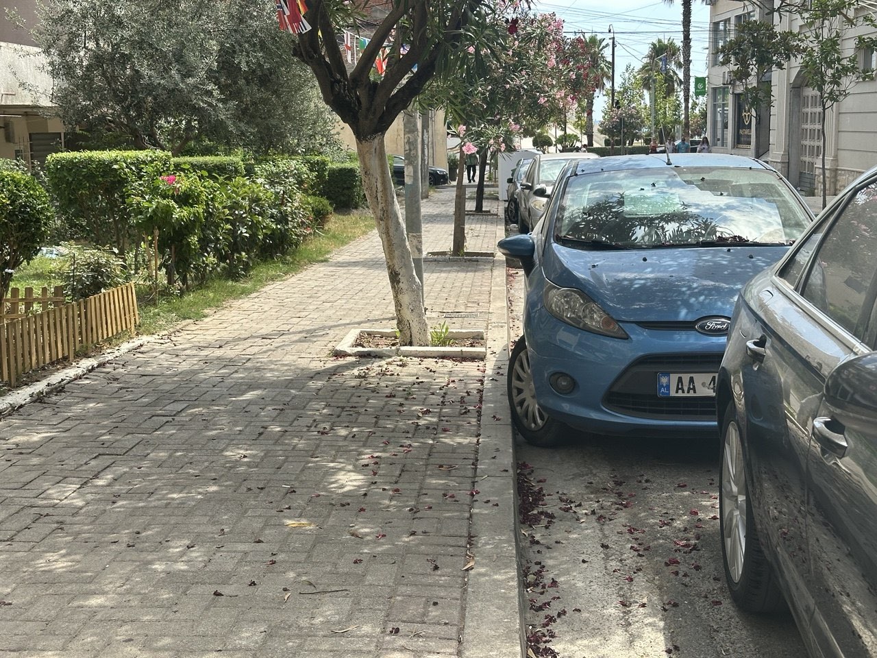 Cars parked across the pavement in Durrës, leaving no room to walk
